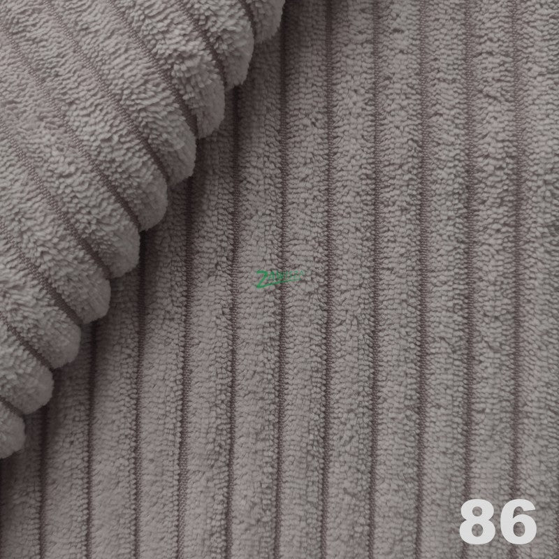 Zdjęcie przedstawiające detale kolorystyczne oraz fakturę tkaniny sztruks, w której może zostać wykonany nowoczesny narożnik skandynawski Scandik L ze sprężynami bonell