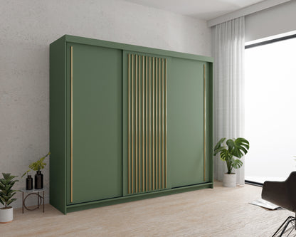 Zdjęcie przedstawiające przykładową aranżację nowoczesnej zielonej szafy z lamelami w złotym kolorze. Zielona szafa przesuwna Artist to nowoczesne rozwiązanie do Twojej sypialni lub salonu