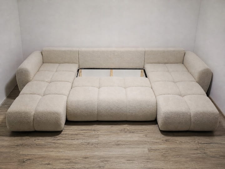 Na zdjęciu prezentuje się obszerny pojemnik na pościel w narożniku Agnello