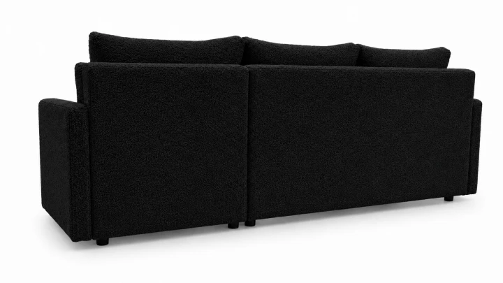 Zdjęcie przedstawiające tył narożnika rozkładanego do salonu Teddy w czarnej tkaninie boucle. Rogówka z funkcją spania Teddy jest meblem wolnostojącym
