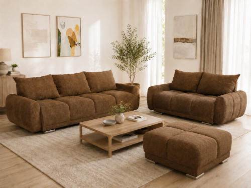 Na zdjęciu przedstawiono zestaw wypoczynkowy do salonu Honey rozkładana i sofa dwójka oraz duża pufa Cappuccino Boucle